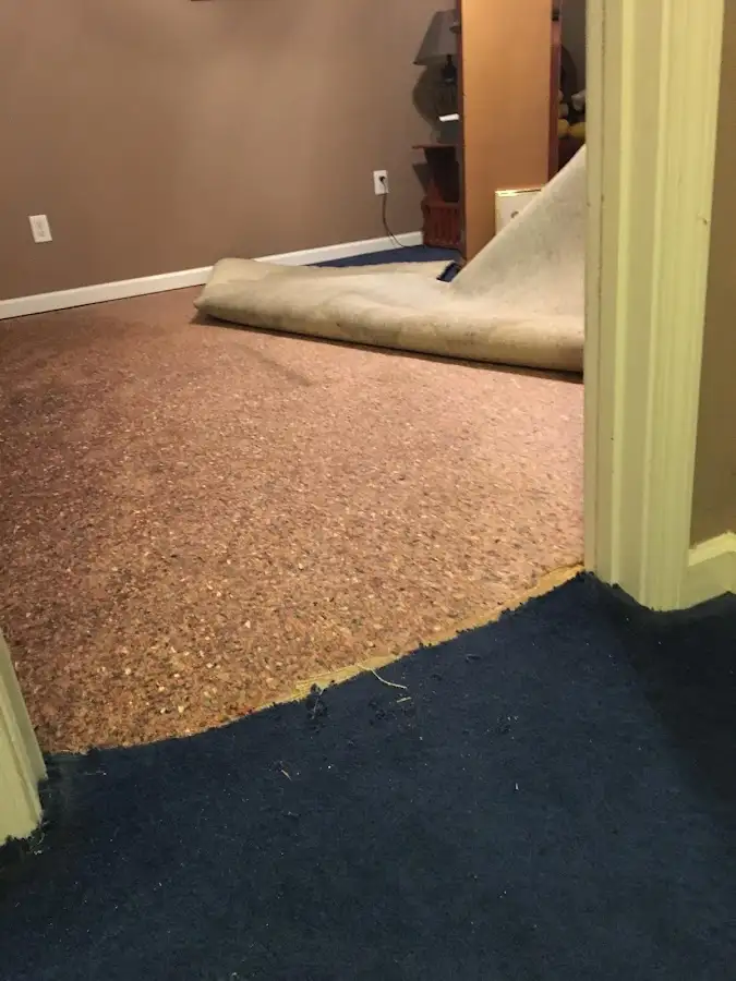 Carpet pad removal revealing water damage during Drying & Dehumidification in Lake Norman of Catawba
